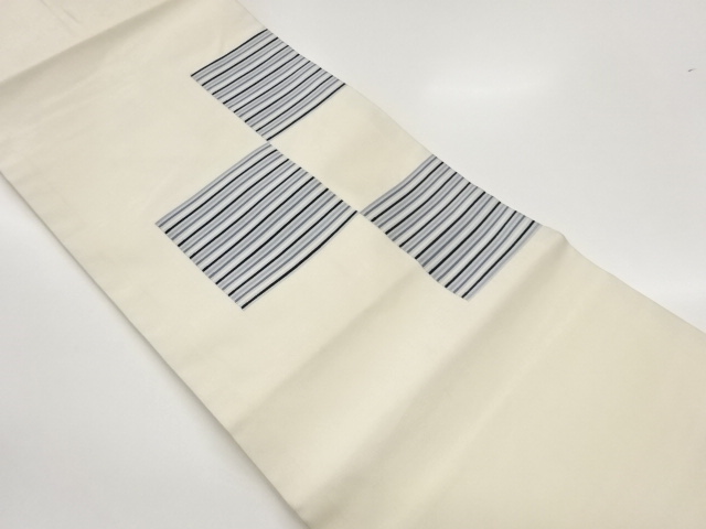 Nagoya obi woven with horizontal tiered pattern on colored paper